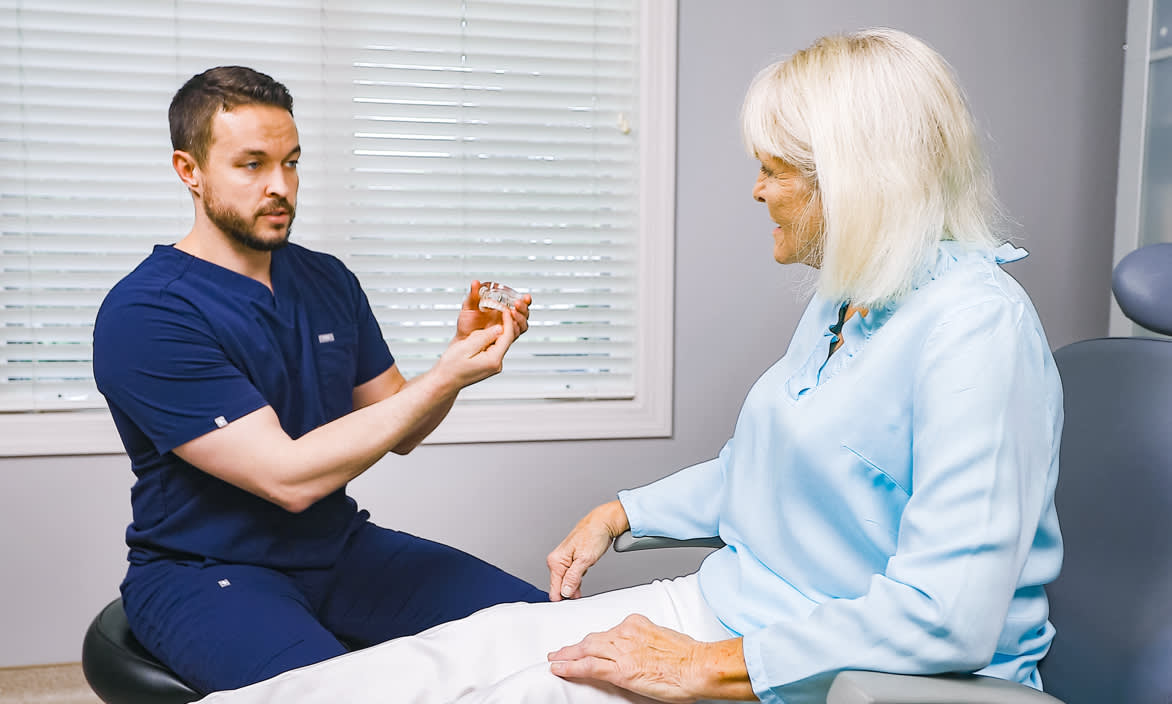 Dr. Barefoot educating a patient about dental implants