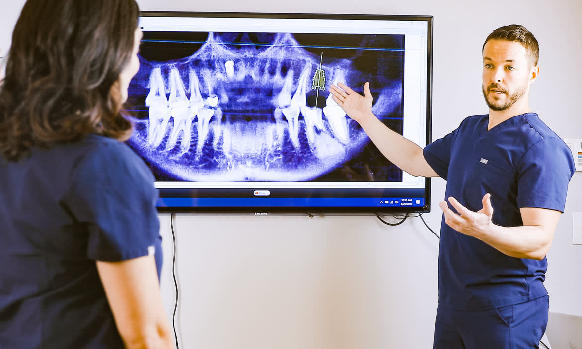 Dr. Barefoot talking to staff about an X-ray