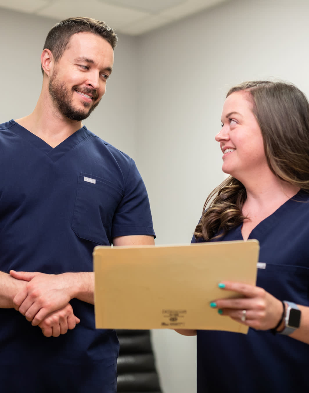 Staff and Dr. Barefoot looking at a client file